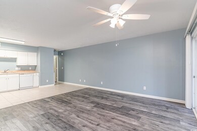 Unfurnished living room featuring ceiling fan, lig