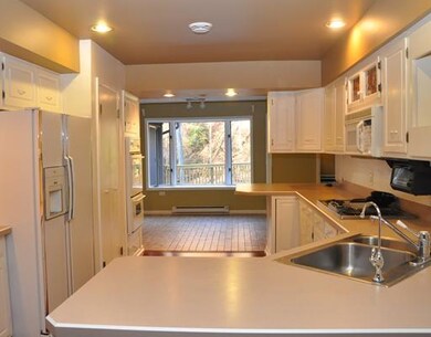 Kitchen. Large open white kitchen, breakfast nook 