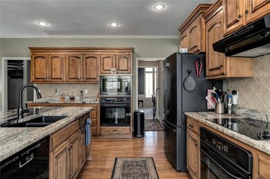 Kitchen with double ovens and stone counters