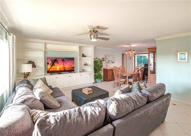 Living area with ornamental molding, ceiling fan w