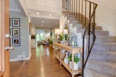Welcoming entrance with tall ceilings with stairwell leading to the upstairs bedrooms