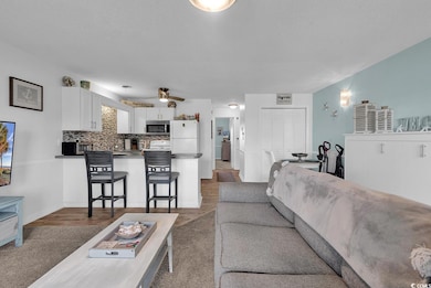 Living area with wood finished floors and a textured ceiling