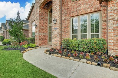 Fresh flowers and double coach lights make this front entry warm and welcoming to you and your guests.