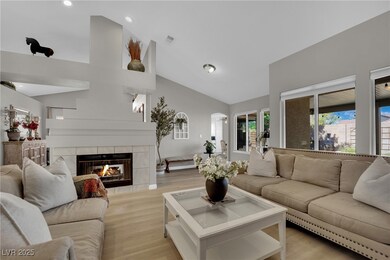 Living area with a tile fireplace, recessed lighti