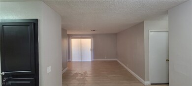 Corridor featuring light wood finished floors, a t