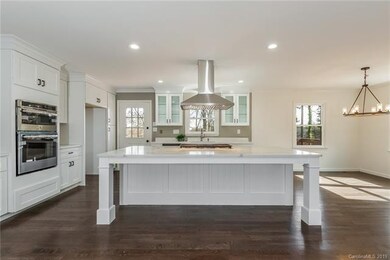 The modern Gourmet Kitchen is to die for. The huge island with 5 burner gas cooktop and canopy hood also has lots of space for everyone to hang out at the eat-in bar.