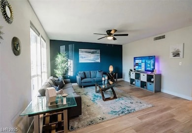 Living room with wood finished floors, a ceiling f