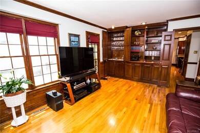 Family room w/ hardwood floors, custom built-in bo