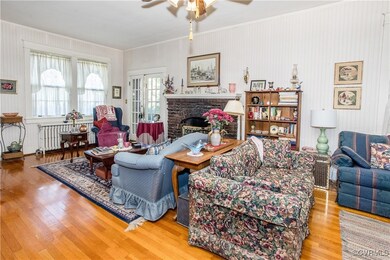 Living room with a fireplace, wood-type flooring,