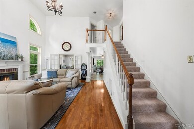 Living area featuring a high ceiling, a brick fire