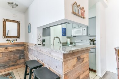 Entryway has a breakfast bar wrapped with wood pan
