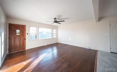 Foyer featuring dark wood-style flooring, a ceiling fan, and beam ceiling