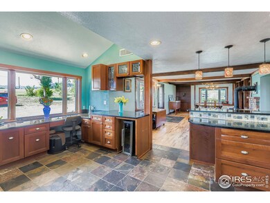 Kitchen features a home office nook and bar seating with mini fridge.