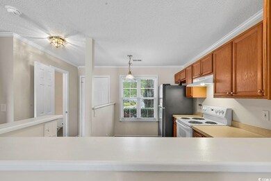 Kitchen with pendant lighting, a textured ceiling,