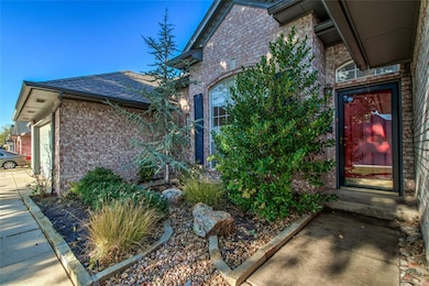 Doorway to property with brick siding, roof with shingles, and an attached garage
