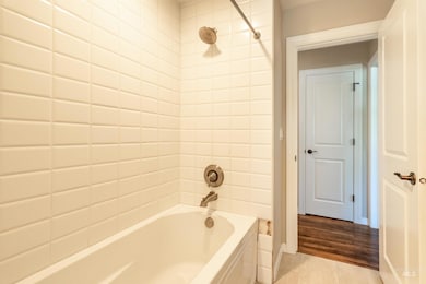 Bathroom with  shower combination and tile patterned flooring