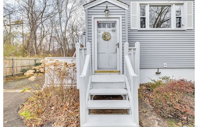 Steps up to the front porch entry leads to a slate tiled floor entryway. There are additional steps up to the main level.