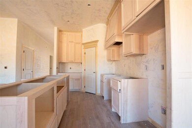 Kitchen with hardwood / wood-style flooring