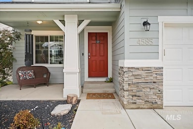 Entrance to property with stone siding and a porch