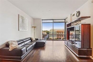 Living room featuring dark hardwood / wood-style flooring and floor to ceiling windows