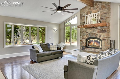 Great room living area featuring beamed vaulted ce