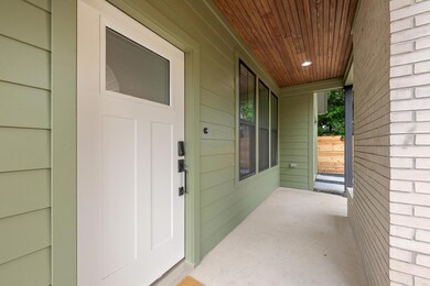 Entrance to property featuring covered porch
