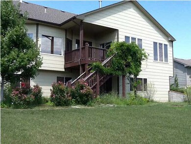Back of home, covered deck and walkout basement