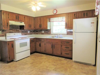 This eat-in kitchen has newer vinyl flooring, a pa