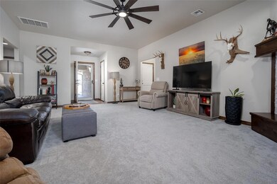 Carpeted living room with ceiling fan