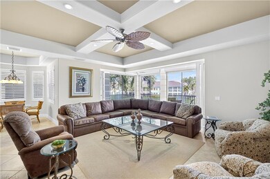 Living area featuring light tile patterned floors, coffered ceiling, a ceiling fan, beam ceiling, and recessed lighting