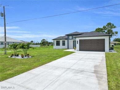 View of front of house with stucco siding, an atta