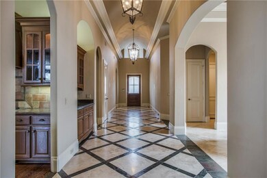 Opulent entry with travertine & slate flooring and