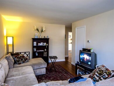 Living Room with closet and hardwood floors