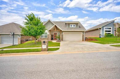Craftsman house with a garage and a front lawn