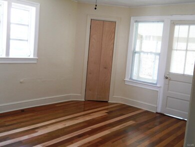 Back bedroom with hardwood floor, ceiling fan and 