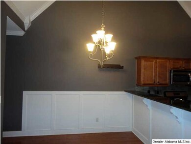 Dining area with crown molding and decorative wain