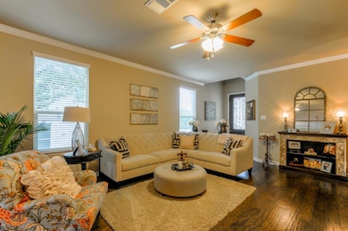Living room featuring dark wood-style flooring, c