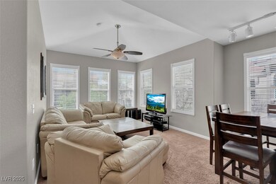 Living area with track lighting, ceiling fan, ligh