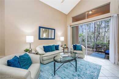 Living room featuring high vaulted ceiling and lig