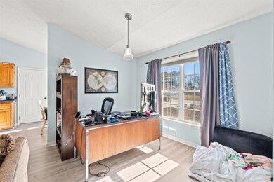 Office space featuring a textured ceiling, light h