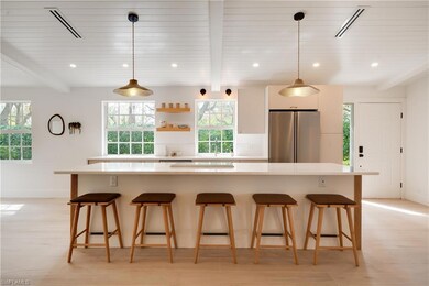 Kitchen featuring a kitchen bar, a kitchen island,
