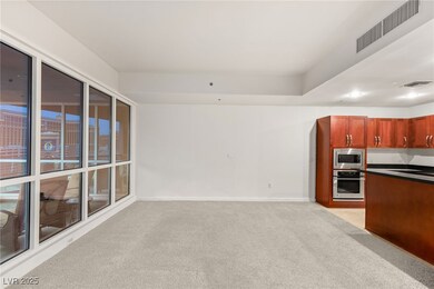 Kitchen featuring visible vents, light carpet, dar