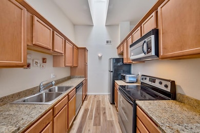 7121 Stella Lane, Unit 24, Carmichael, CA 95608 - Full kitchen view with skylight and stainless steel finished appliances. Lot's of storage too.