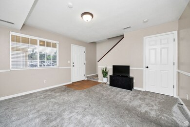 Foyer featuring carpet floors and stairway