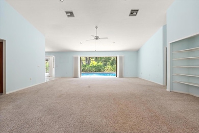 Living room with 12' sliding glass doors that pocket away to pool.