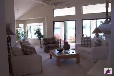 Living room is light and airy. Windows have sun sh
