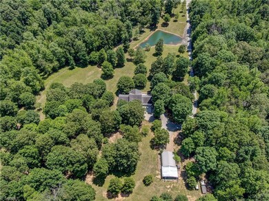 View from backyard looking towards to road. Large garage/shop/storage building.