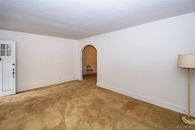 Empty room featuring light carpet