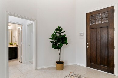 Alternate view of the foyer and a hallway leading to the first-floor secondary bedroom, and a full bathroom.