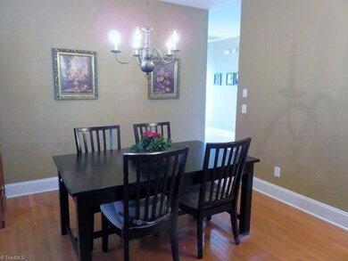 Dining room opens to hall and kitchen. Notice the wide base  molding throughout.